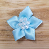 Ribbon flower with pearl centre